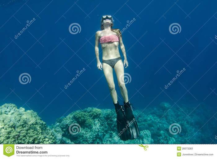 woman-free-diving-snorkeling-coral-reef-28373283.jpg